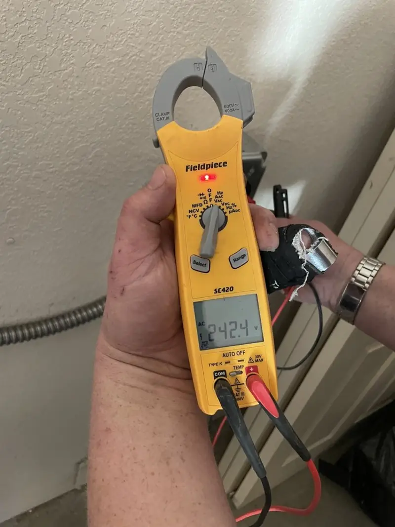 Voltage testing with clamp meter during Recessed Lighting Installation in Connell